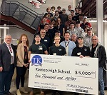 Photo of Romeo High School being presented with $5,000 check